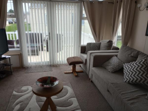 E31 is a 2 bedroom 6 berth caravan with large decking and close to beach on Whitehouse Leisure Park This is a pet free caravan